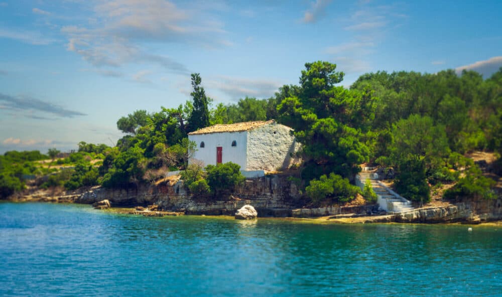 White Greek Chapel Surrounded By Blue Sea, Paxos Greece