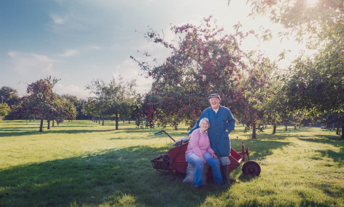 Chris And Carole Take A Break In Their Orchard. Crest Cyder Makers Somerset