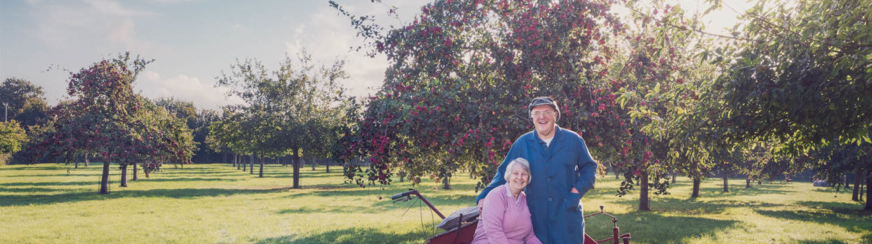 Chris And Carole Take A Break In Their Orchard. Crest Cyder Makers Somerset